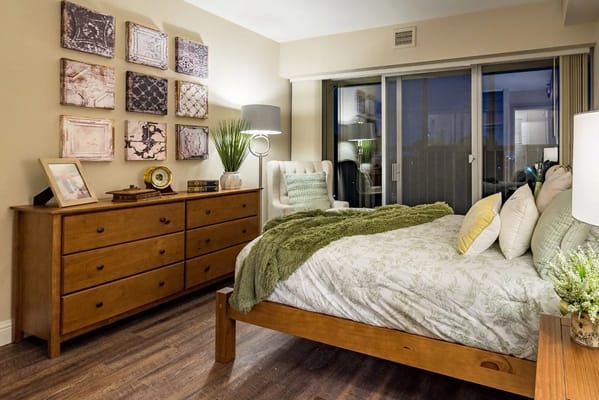 Comfortable bedroom featuring a bed, dresser, and decorative wall art