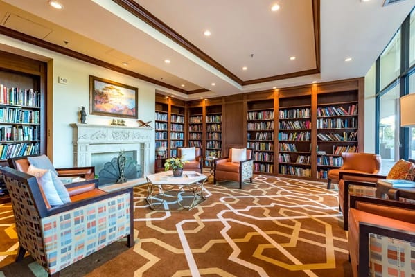 Inviting library lounge with bookshelves and seating at The Park Lane