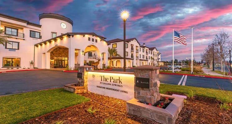 Entrance of The Park at Laguna Springs with sunset sky