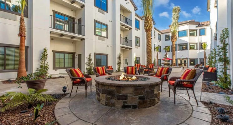 Cozy fire pit surrounded by seating at The Park at Laguna Springs Independent Living Community.