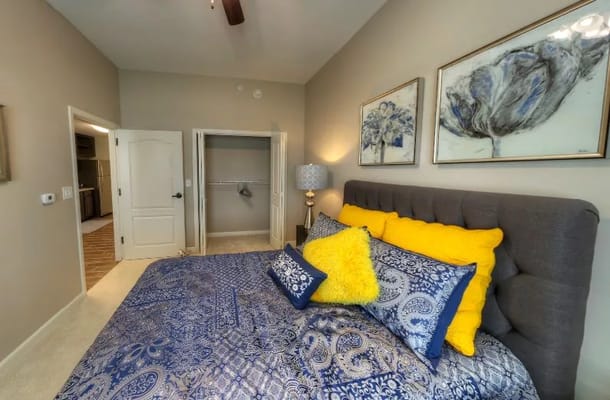 A stylishly decorated bedroom with blue and yellow accents