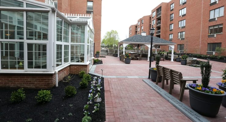 A beautifully landscaped courtyard with seating and a gazebo