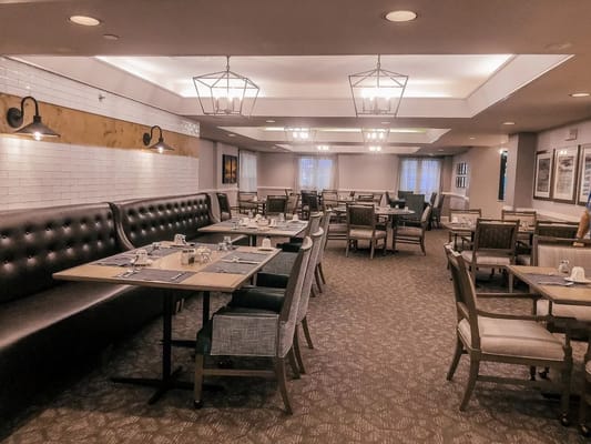 Spacious dining room with wooden tables and comfortable seating