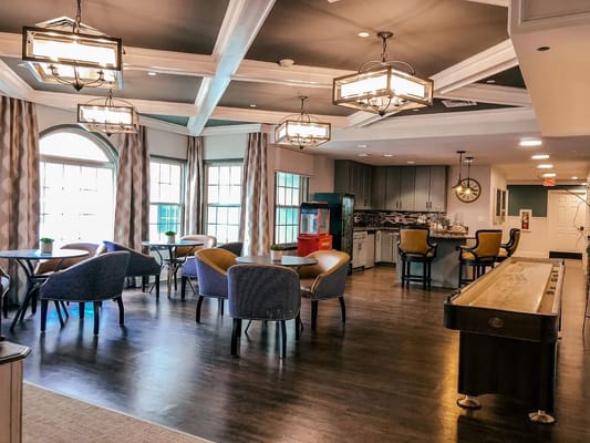 Bright and inviting common area with seating and a kitchen.