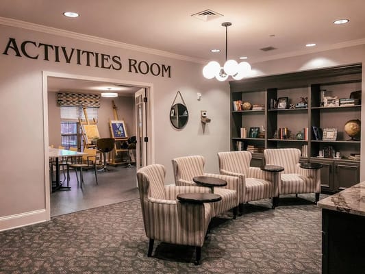 Cozy activities room with seating and bookshelves