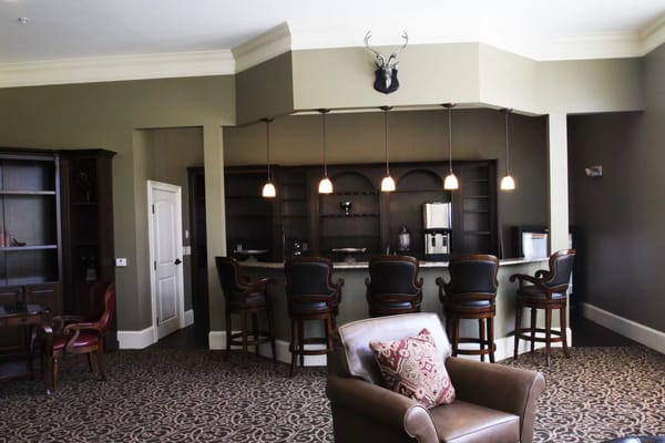 Cozy lounge area with a bar-style seating and decorative antlers