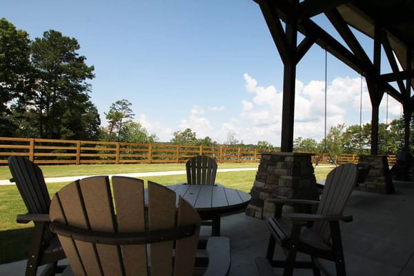 Patio seating with a view of trees and blue sky