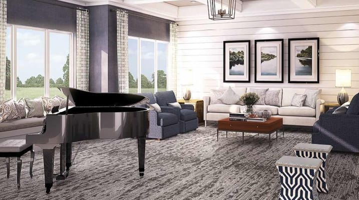 Living room featuring a grand piano, cozy seating, and large windows.