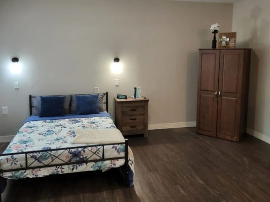 Interior view of a private resident room with bed and storage