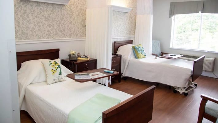 Two resident beds in a bright, shared room