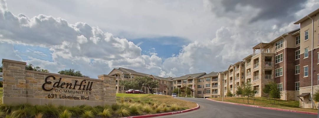 The entrance sign of The Pinnacle at Edenhill with buildings in the background