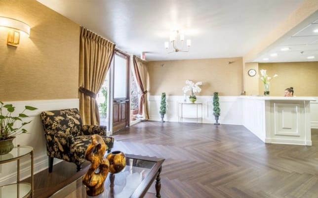 Warm and inviting lobby area with elegant decor, floral arrangements, and a reception desk.
