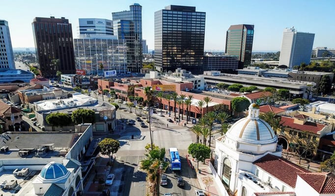 Aerial view of Westwood Blvd showing commercial buildings and palm trees.