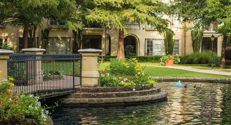 Serene outdoor courtyard with fountain and flowers