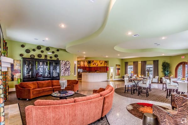 Spacious common area with seating and dining tables in a senior living facility