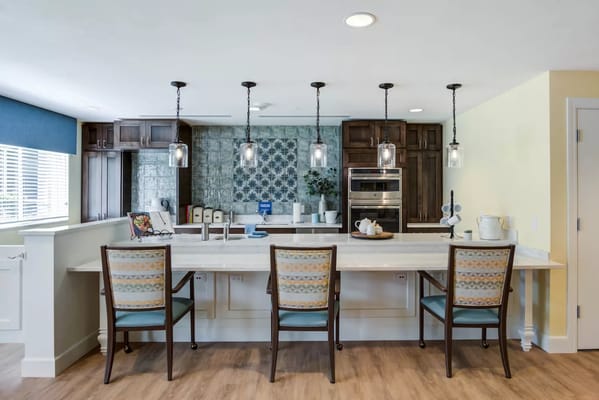 Modern kitchen area with bar seating and pendant lights