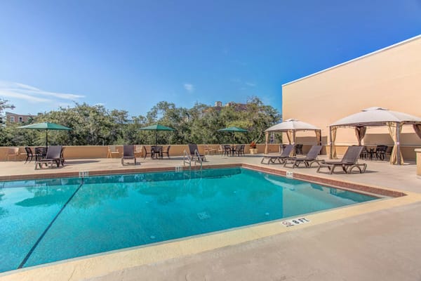 Outdoor swimming pool area with lounge chairs