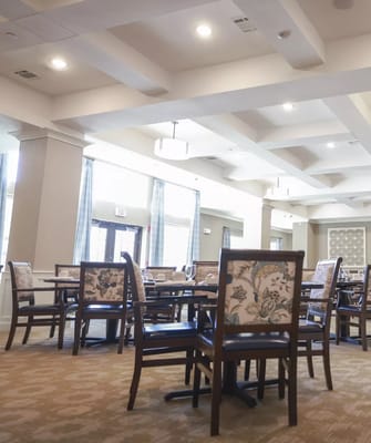 Spacious dining area with wooden tables and chairs