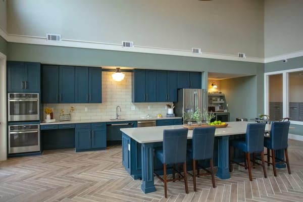 Spacious kitchen area with blue cabinets and a central island