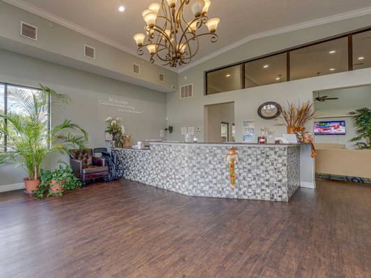 Welcoming lobby area with reception desk and seating at The Regency Park.