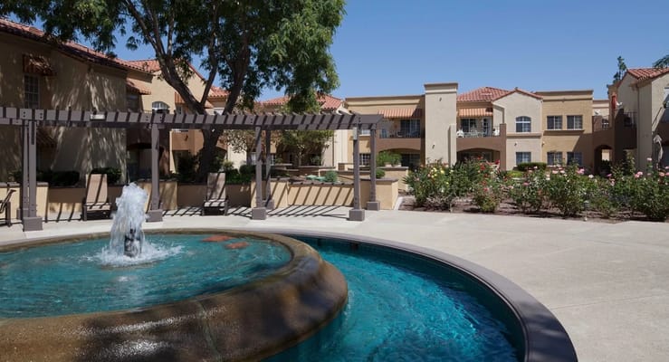 Outdoor courtyard with a fountain and gardens