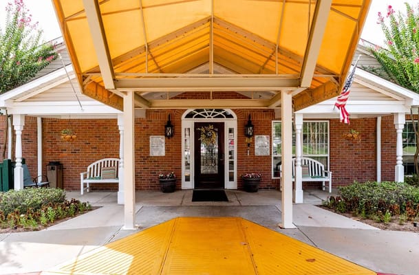 Main entrance with a yellow awning at The Reserve at Royal Oaks