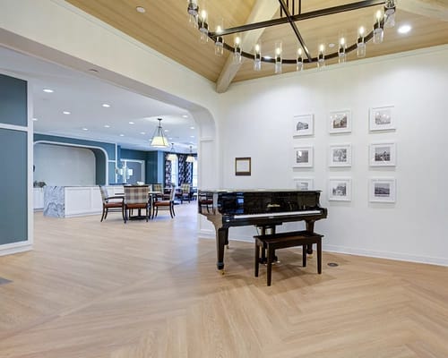 Interior of a common area with a piano and seating