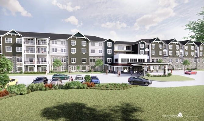 Front entrance of The Residence at Fitz Farm with cars parked and people walking