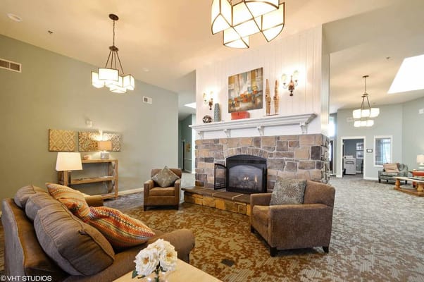Spacious living room with comfortable seating and a stone fireplace