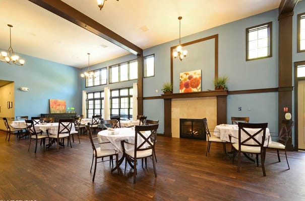 Cozy dining area with tables and a fireplace