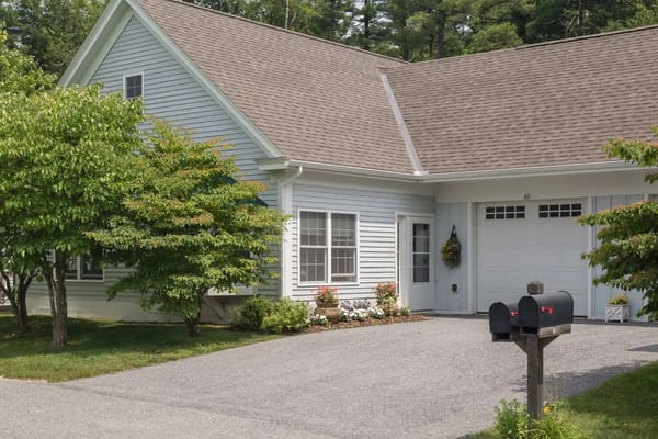 Front view of a cottage-style home at The Residence at Otter Creek with a landscaped yard.