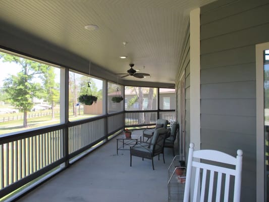 Screened porch with seating and hanging plants