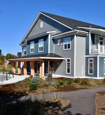 Front view of The Residences at the Essex with landscaped entrance.