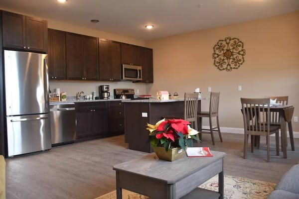 Modern kitchen and dining setup in a senior living apartment