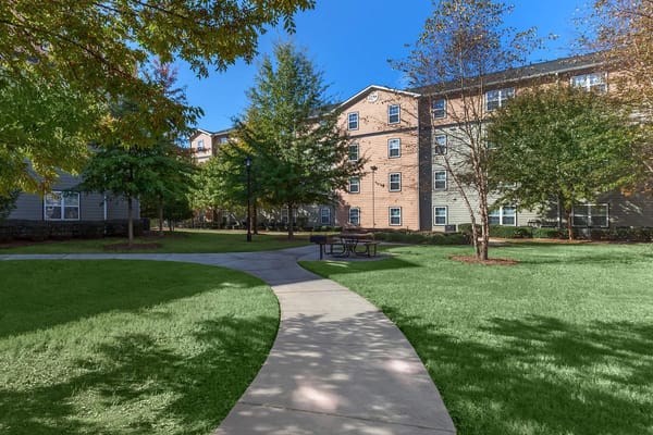 View of landscaped outdoor space with walkways and trees