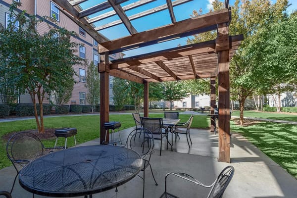 Outdoor seating area with pergola and tables