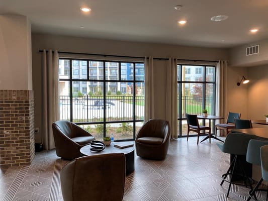 Cozy lounge area featuring armchairs and a view of outdoor space