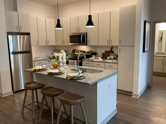 Spacious kitchen with granite countertops and modern appliances