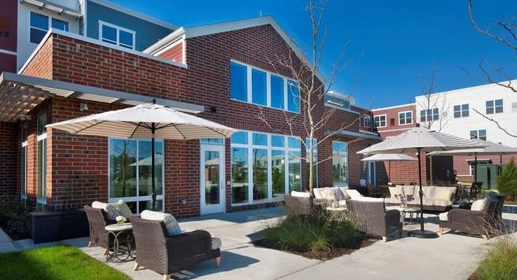 Outdoor seating area with umbrellas at The Sheridan at Bethel Park.