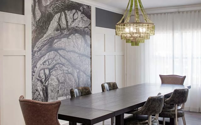 Bright common area with dining table and chandelier