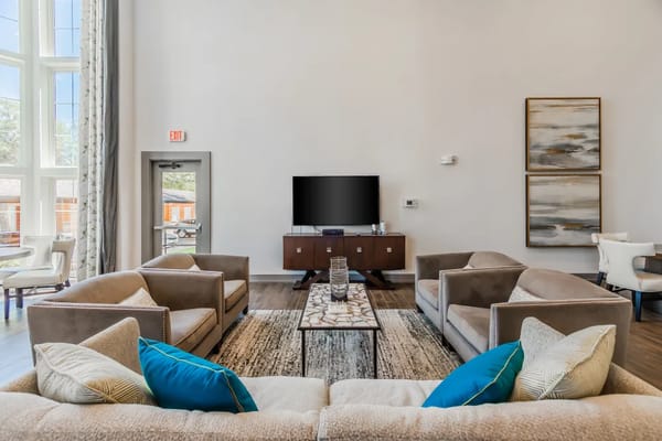 Bright living room with comfortable seating and large windows