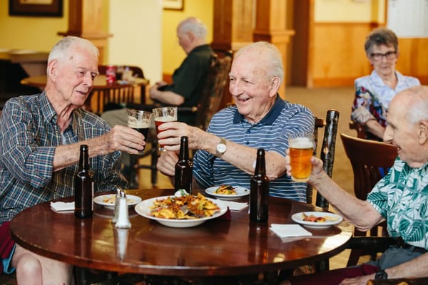 Residents enjoying food and drinks at a social gathering