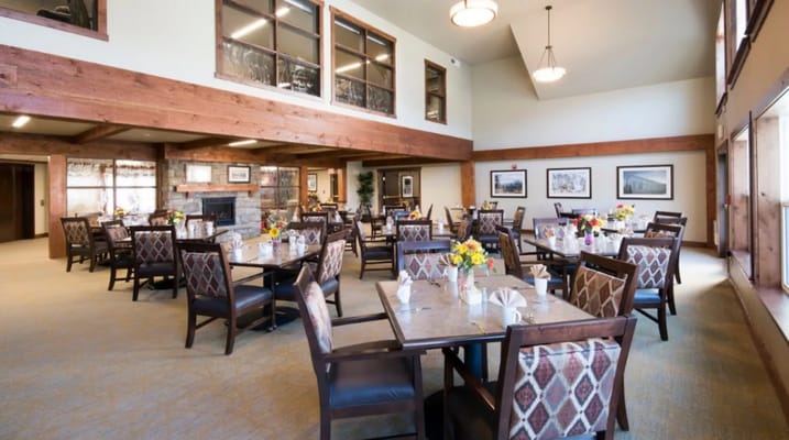 Bright dining room with tables set for meals