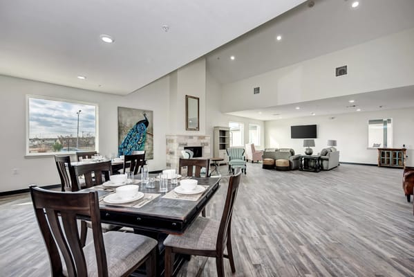 Bright and spacious common area with dining table and seating lounge