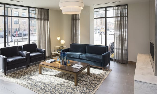 Bright common area with seating and large windows