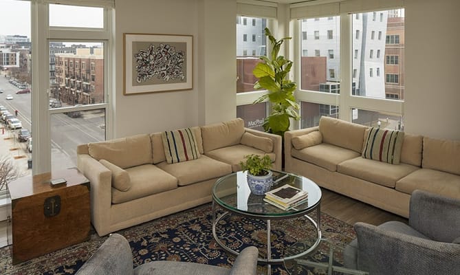 Bright common area with comfortable seating and windows