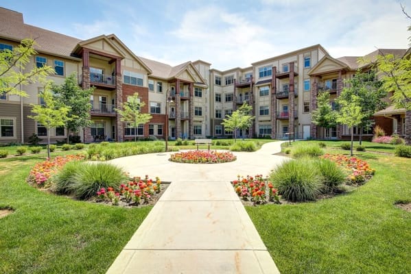 Lush courtyard with garden and apartment buildings at The Terraces of Boise