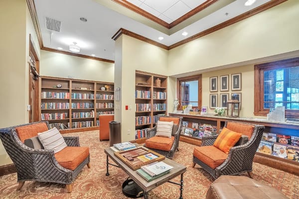 Comfortable seating area in the library with bookshelves.
