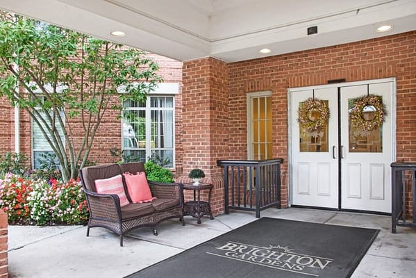 Entrance area of Brighton Gardens with flowers and seating