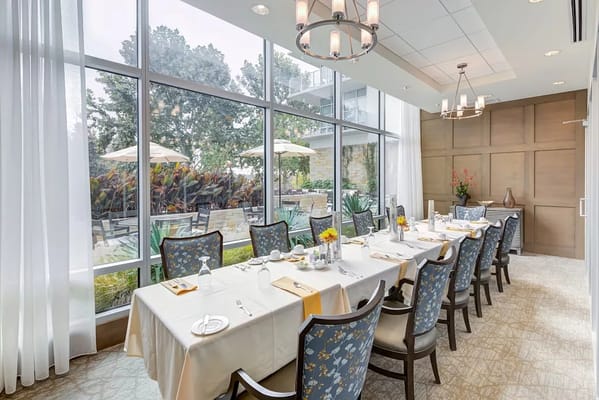 Dining room setup with flowers and table settings